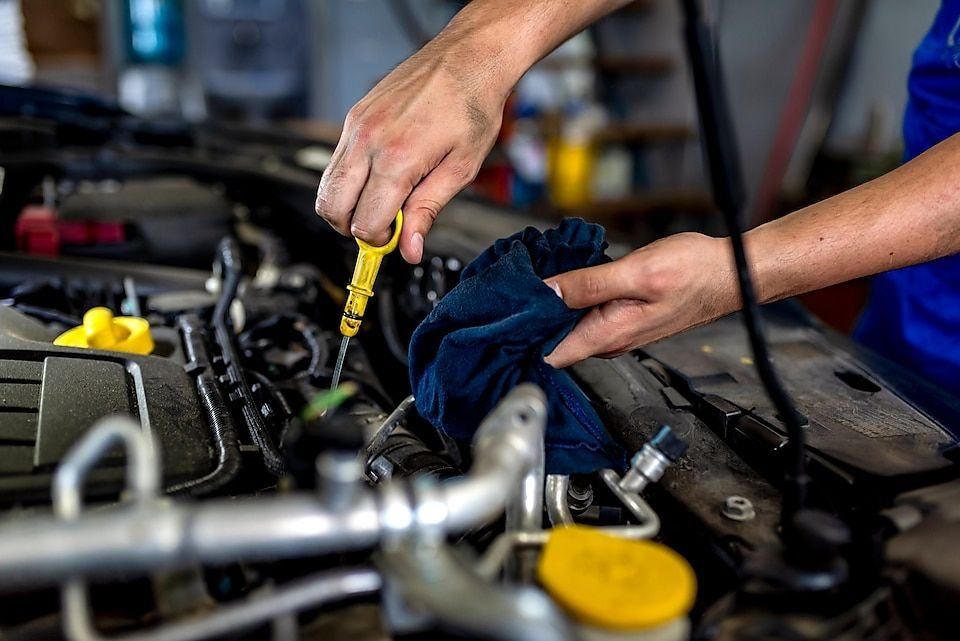 Mechanic checking the engine oil dipstick